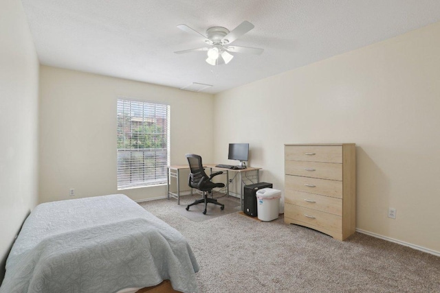 carpeted bedroom featuring baseboards and a ceiling fan