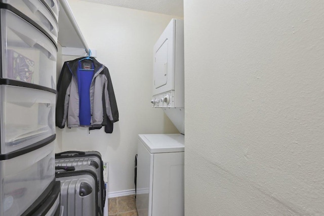 2401 Leon St Unit 210, Austin, TX 78705 - laundry area with stacked washer and clothes dryer and baseboards