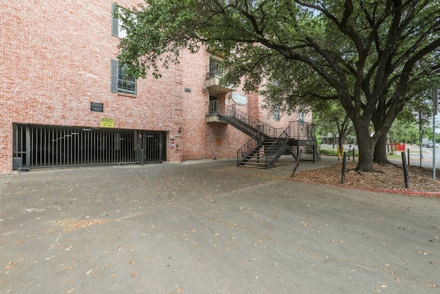 exterior space with brick siding and stairs