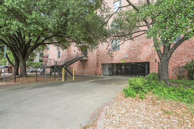 2401 Leon St Unit 210, Austin, TX 78705 - view of building exterior featuring concrete driveway and stairway