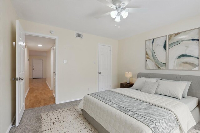 2401 Leon St Unit 210, Austin, TX 78705 - bedroom featuring light colored carpet, baseboards, and ceiling fan