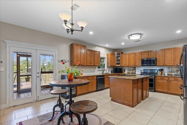 550 League Line Rd, Smithville, TX 78957 - kitchen with appliances with stainless steel finishes, healthy amount of natural light, a kitchen island, brown cabinetry, and recessed lighting
