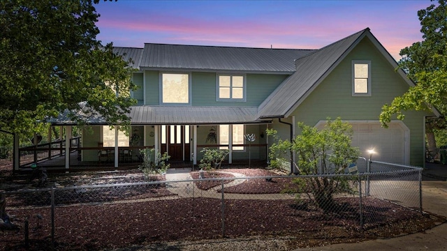 550 League Line Rd, Smithville, TX 78957 - view of front of house featuring covered porch, metal roof, a fenced front yard, and driveway