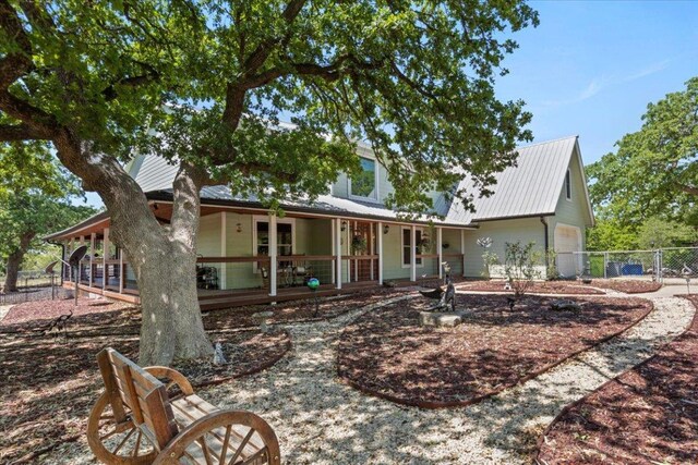 550 League Line Rd, Smithville, TX 78957 - rear view of property featuring covered porch, metal roof, and a garage