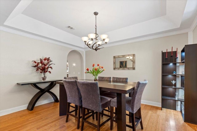 550 League Line Rd, Smithville, TX 78957 - dining room featuring a raised ceiling, a chandelier, arched walkways, and crown molding