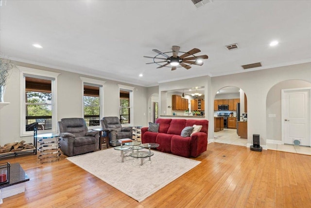550 League Line Rd, Smithville, TX 78957 - living area featuring arched walkways, ceiling fan, light wood finished floors, recessed lighting, and ornamental molding