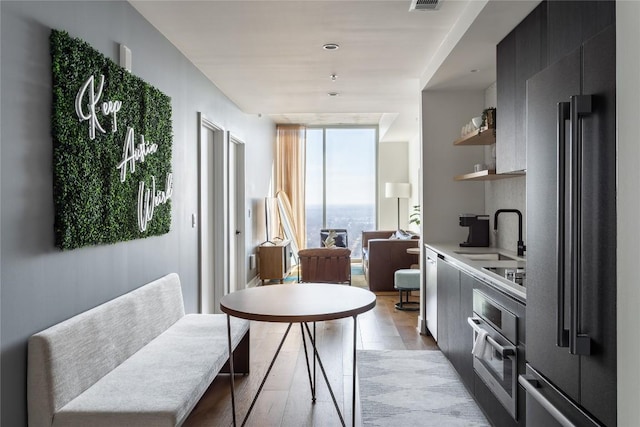 interior space featuring a sink, open shelves, modern cabinets, and appliances with stainless steel finishes