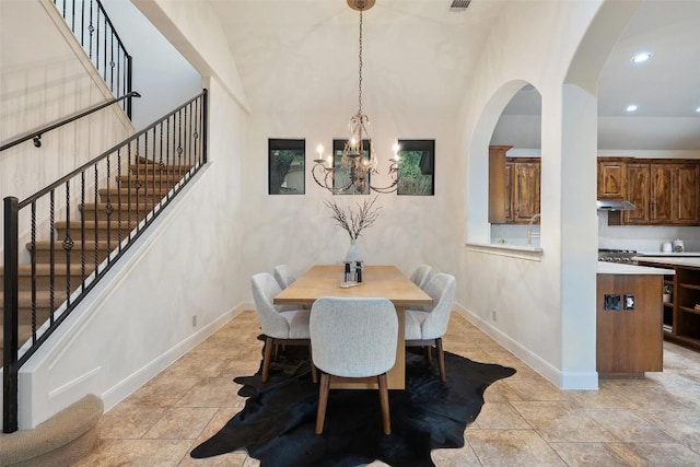 13606 Montview Dr, Austin, TX 78732 - dining room featuring a chandelier, stairs, recessed lighting, baseboards, and arched walkways