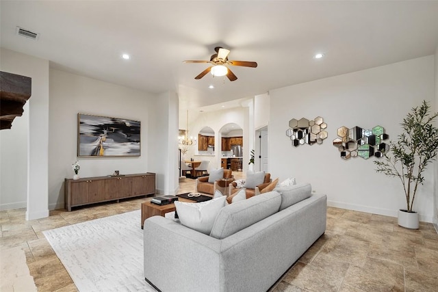 13606 Montview Dr, Austin, TX 78732 - living room with arched walkways, a ceiling fan, recessed lighting, and light stone finish floors