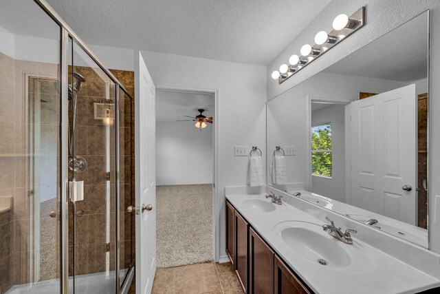 1013 Hondo Ln, Hutto, TX 78634 - bathroom with double vanity, a sink, a ceiling fan, and a stall shower