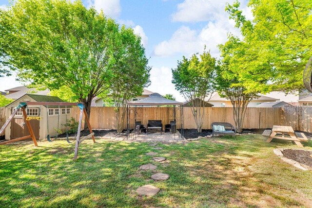 1013 Hondo Ln, Hutto, TX 78634 - view of yard with a storage unit, a fenced backyard, a patio area, and an outbuilding
