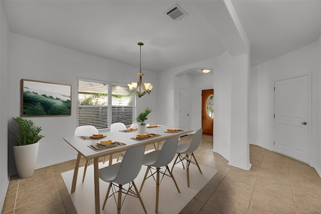 dining room featuring arched walkways, light tile patterned flooring, visible vents, and a healthy amount of sunlight