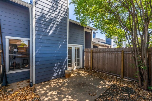 view of patio with french doors and fence