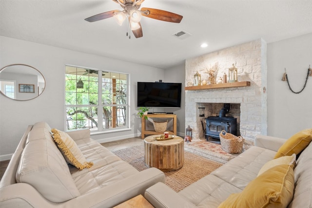 12099 Bonham Ranch Rd, Dripping Springs, TX 78620 - living area with a wood stove, baseboards, and plenty of natural light