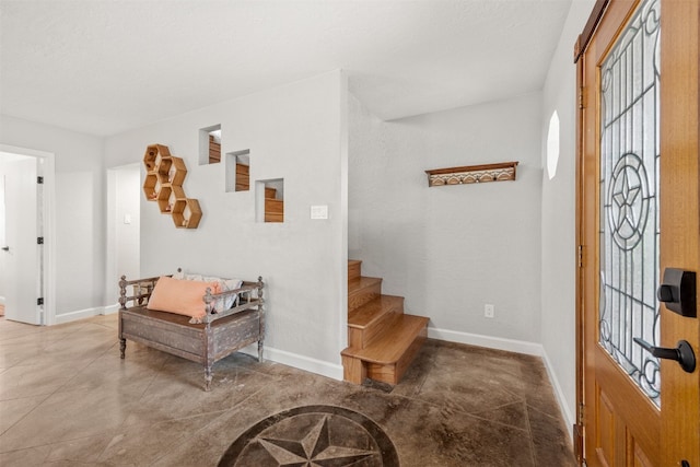 12099 Bonham Ranch Rd, Dripping Springs, TX 78620 - entryway with baseboards, stairway, and concrete flooring