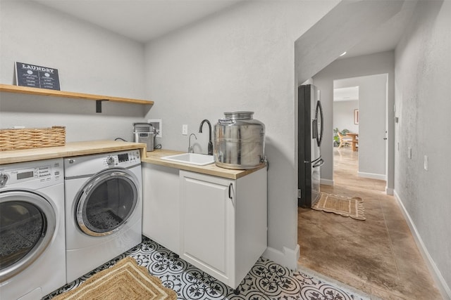 12099 Bonham Ranch Rd, Dripping Springs, TX 78620 - clothes washing area featuring washer and clothes dryer and baseboards