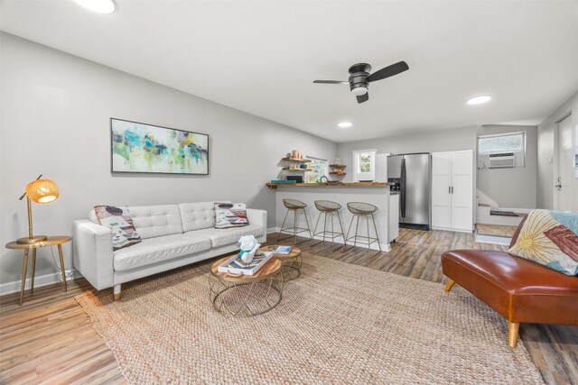 12099 Bonham Ranch Rd, Dripping Springs, TX 78620 - living area with light wood-style flooring, stairs, a ceiling fan, baseboards, and healthy amount of natural light