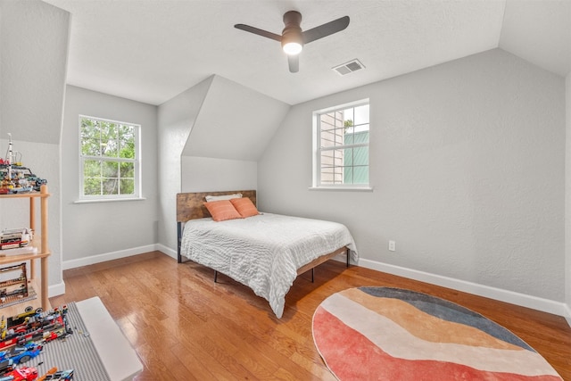 12099 Bonham Ranch Rd, Dripping Springs, TX 78620 - bedroom with lofted ceiling, wood finished floors, ceiling fan, and baseboards