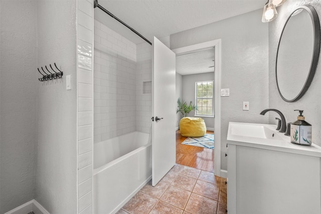 12099 Bonham Ranch Rd, Dripping Springs, TX 78620 - bathroom with tile patterned flooring, vanity, baseboards, shower / washtub combination, and a textured wall