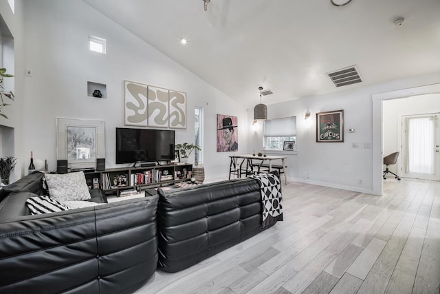 2928 E 13th St Unit B, Austin, TX 78702 - living area featuring high vaulted ceiling, baseboards, visible vents, and light wood-type flooring