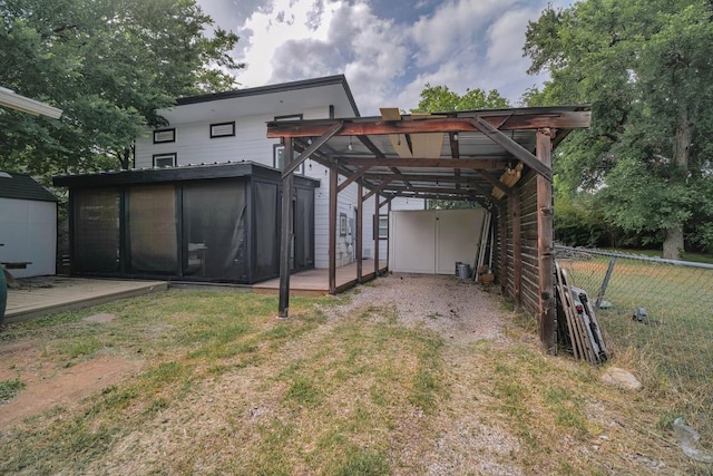 2928 E 13th St Unit B, Austin, TX 78702 - view of shed with dirt driveway, a detached carport, a sunroom, and fence