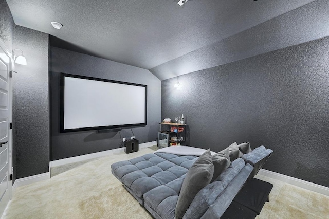 home theater with carpet flooring, a textured ceiling, lofted ceiling, and a textured wall