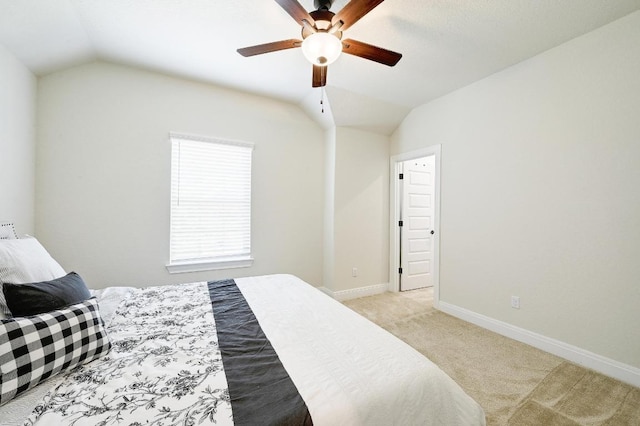 carpeted bedroom featuring baseboards, a ceiling fan, and vaulted ceiling