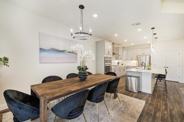 dining area with visible vents, baseboards, dark wood-style flooring, recessed lighting, and a notable chandelier
