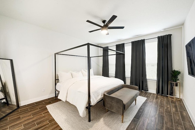 bedroom with ceiling fan, wood finished floors, and baseboards
