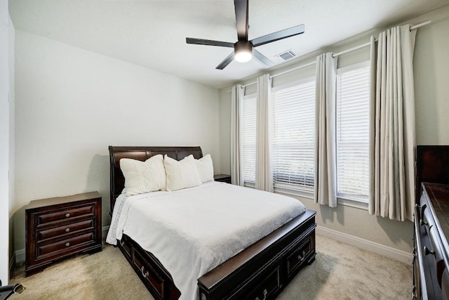 bedroom with visible vents, ceiling fan, light colored carpet, and baseboards