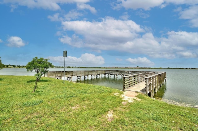 dock area featuring a yard and a water view
