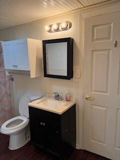 109 Tennessee St, Taylor, TX 76574 - full bathroom with wood ceiling, wood finished floors, vanity, and toilet