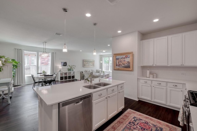 kitchen featuring stainless steel appliances, a sink, white cabinets, dark wood-style flooring, and recessed lighting