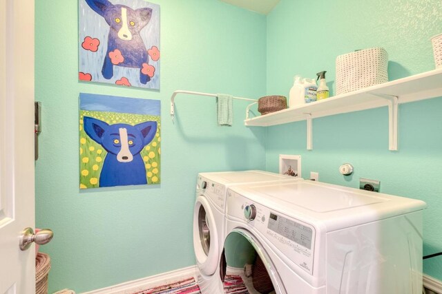 clothes washing area with washer and dryer
