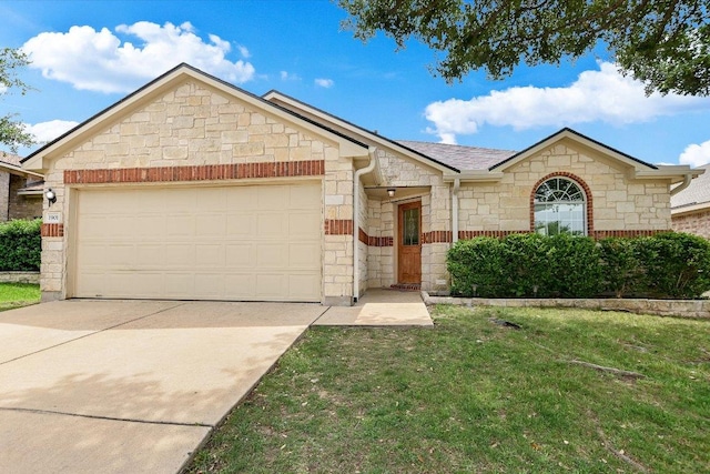 1901 Rachel Ln, Round Rock, TX 78664 - ranch-style house featuring stone siding, concrete driveway, a front yard, and a garage