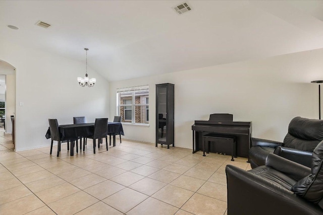 1901 Rachel Ln, Round Rock, TX 78664 - dining space featuring light tile patterned flooring, a chandelier, arched walkways, vaulted ceiling, and baseboards