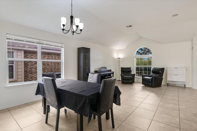 1901 Rachel Ln, Round Rock, TX 78664 - dining area with lofted ceiling, a chandelier, light tile patterned floors, and baseboards