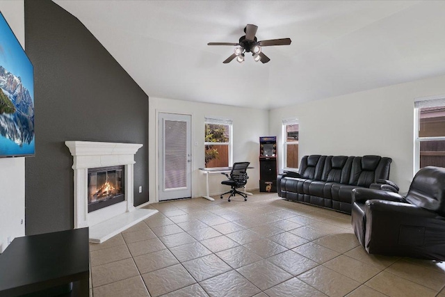 1901 Rachel Ln, Round Rock, TX 78664 - living room with a ceiling fan, tile patterned floors, a glass covered fireplace, and baseboards