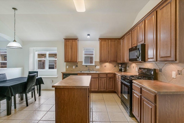 1901 Rachel Ln, Round Rock, TX 78664 - kitchen featuring black appliances, a sink, backsplash, a center island, and brown cabinetry