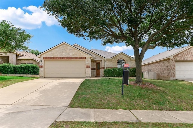 1901 Rachel Ln, Round Rock, TX 78664 - ranch-style home with an attached garage, stone siding, a front yard, and concrete driveway