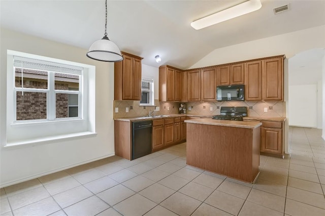 1901 Rachel Ln, Round Rock, TX 78664 - kitchen featuring black appliances, vaulted ceiling, decorative backsplash, a center island, and light tile patterned floors