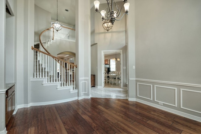 3803 Bobby Jones Way, Round Rock, TX 78664 - foyer with a chandelier, a high ceiling, hardwood / wood-style flooring, stairway, and a wainscoted wall
