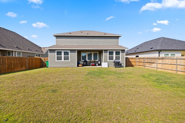 17717 Zinfandel Dr, Pflugerville, TX 78660 - back of property with a fenced backyard, a patio, and a lawn