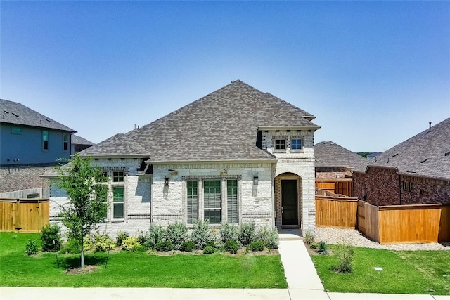 3049 Sage Ranch Dr, Leander, TX 78641 - french country style house featuring a shingled roof and brick siding