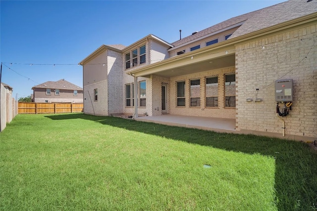 3049 Sage Ranch Dr, Leander, TX 78641 - rear view of property featuring a fenced backyard, a patio area, brick siding, and water heater
