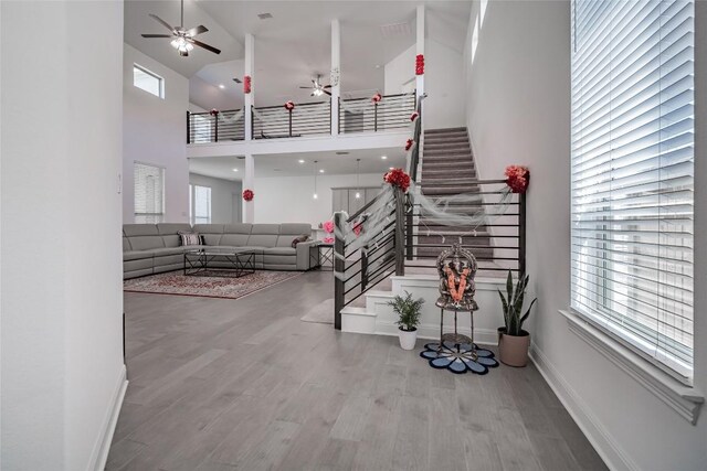 3049 Sage Ranch Dr, Leander, TX 78641 - living room with a ceiling fan, a high ceiling, wood finished floors, and stairway