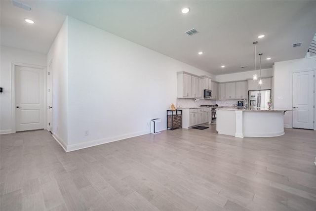 3049 Sage Ranch Dr, Leander, TX 78641 - unfurnished living room featuring light wood-style floors and recessed lighting