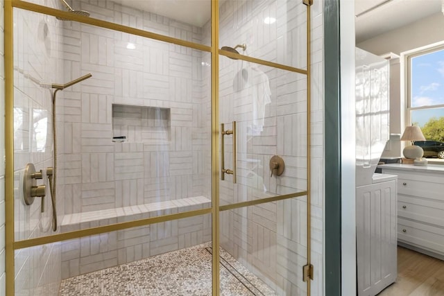 full bath with a shower stall and vanity