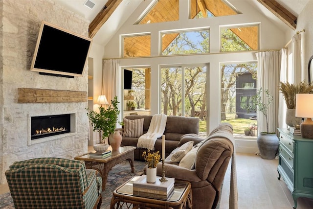 sunroom with visible vents and beamed ceiling