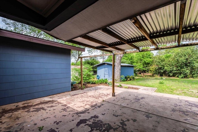 view of patio with an outbuilding and a storage unit
